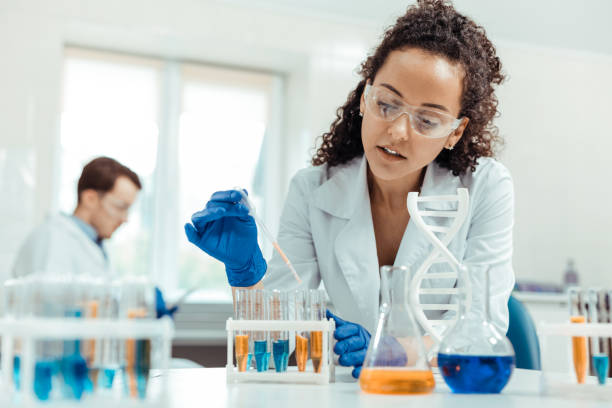 istock Professional female scientist taking a vaccine sample 1156456280