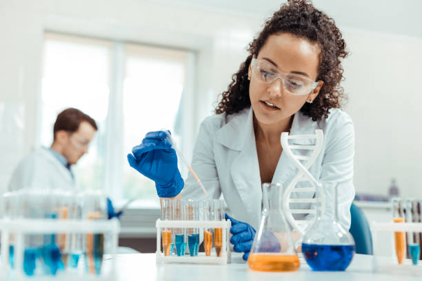 Professional female scientist taking a vaccine sample Modern scientific research. Professional female scientist taking a vaccine sample while conducting a research science research stock pictures, royalty-free photos & images