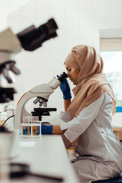 istock Serious thoughtful woman studying test samples in the bio lab 1156456840