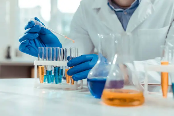 Chemical samples. Close up of test tubes being used by a smart skilled scientist in the chemical lab