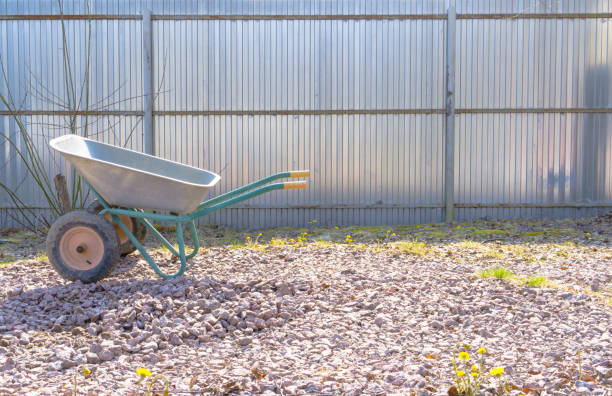 istock Gardening Tools. Iron wheelbarrow on the rubble 1156457384