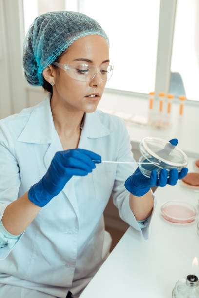 istock Nice thoughtful woman holding a petri dish 1156457453