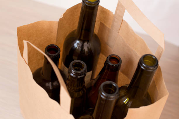 istock empty glass liquor bottles in a paper bag 1156458387