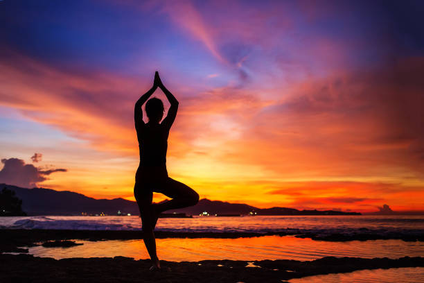 istock Caucasian woman practicing yoga at seashore 1156458453