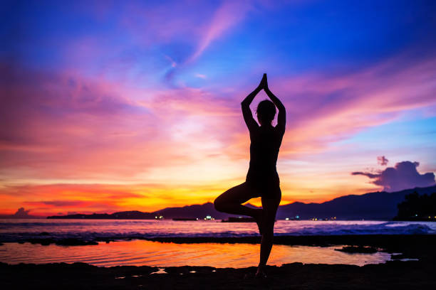 istock Caucasian woman practicing yoga at seashore 1156458456
