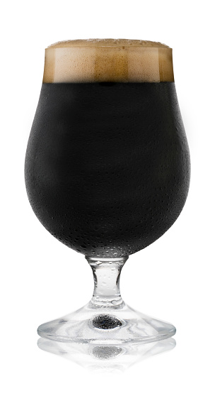 Isolated image of a refreshing glass of stout, in a schooner glass, with condensation