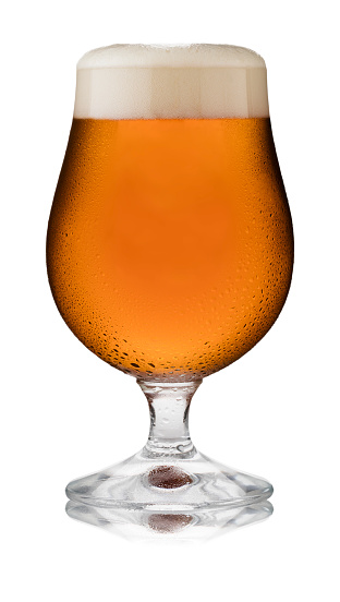 Isolated image of a refreshing glass of traditional ale, in a schooner glass, with condensation