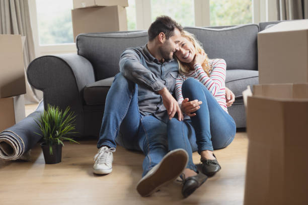 istock Romantic couple sitting together in new home 1156460409