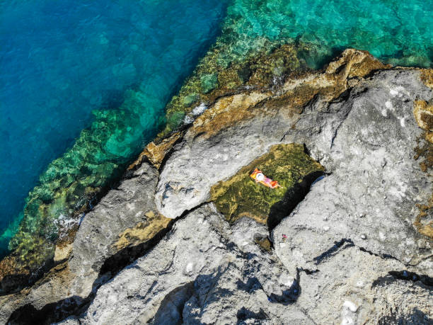istock Woman floating in pool formed in nature. 1156461321