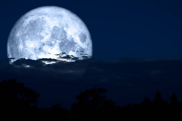 istock full lenten moon back on silhouette cloud and mountain on night sky 1156461977
