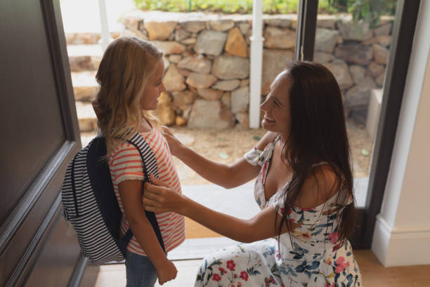 istock Mother preparing her daughter for school at home 1156462038