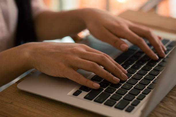 istock Hands with neat nails on the keyboard of laptop 1156464149