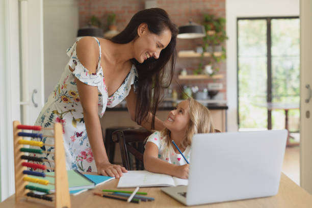 istock Mother helping her daughter with homework in a comfortable home 1156464232