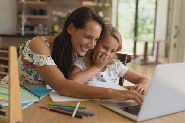 istock Mother helping her daughter with homework in a comfortable home 1156464369