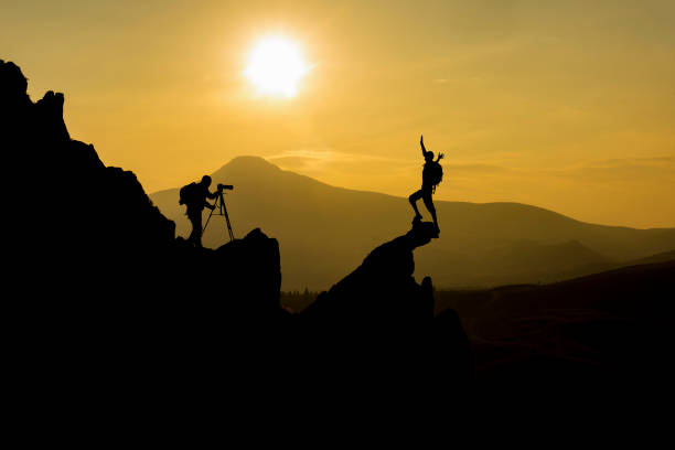 photographer and brave model working concept - rock norway courage mountain imagens e fotografias de stock