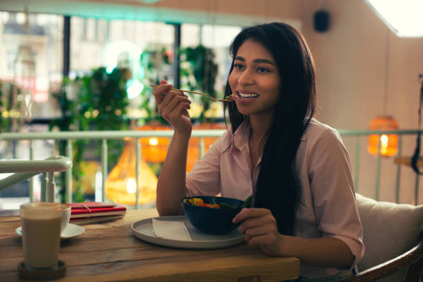 istock Long haired woman thoughtfully eating salad it the cafe 1156465407
