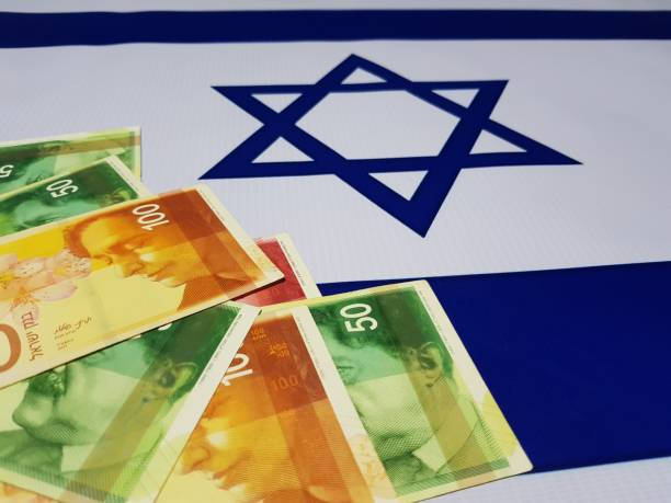 istock Israeli banknotes placed on the national flag 1156465672