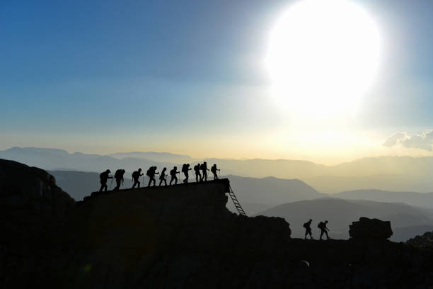 istock adventurous mountaineers triumph and march on high peaks 1156465725
