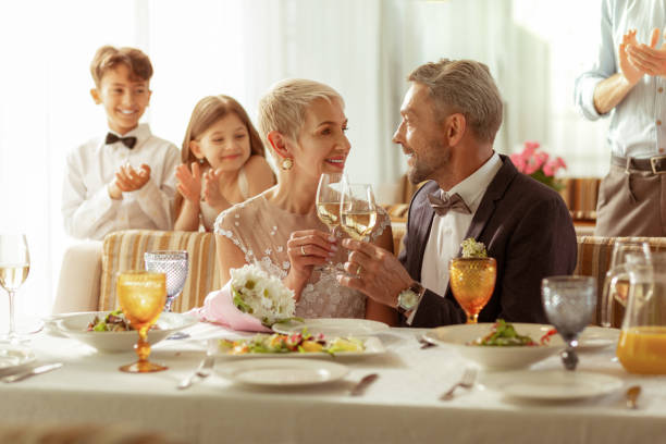 istock Aged bridge and groom clanging their glasses with champagne 1156466169