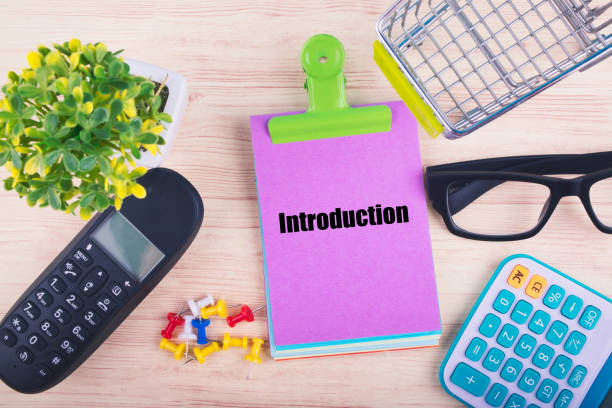 istock top view of notepad with word INTRODUCTION, mobile phone, calculator, and other accessories on wooden background 1156466246