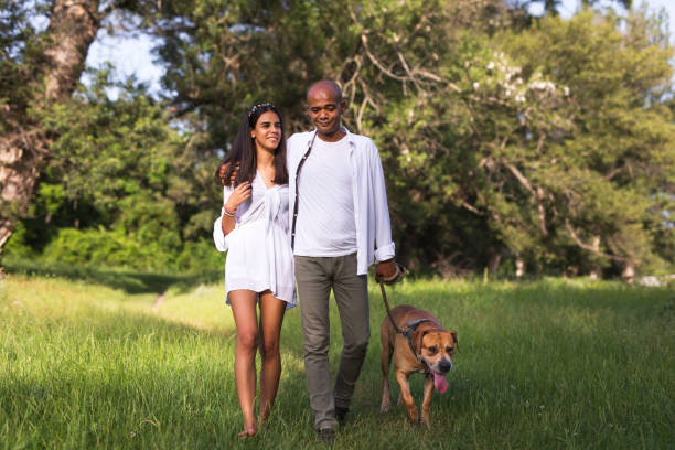 istock Father and daughter walking with dog 1156466496