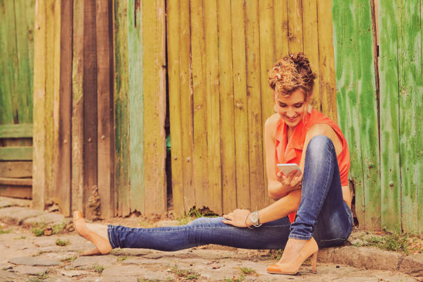 istock Beautiful woman using cellphone on the street. 1156470761