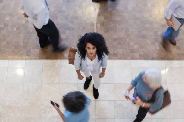 istock Mixed race teacher looks up at camera 1156472987