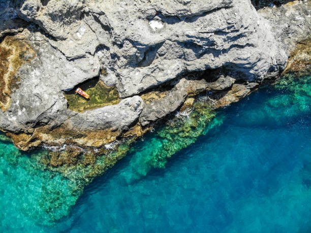 istock Woman floating in desert bay. 1156473226