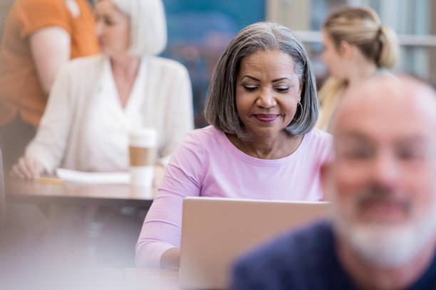 istock Mature adult student focuses on computer assignment 1156473590