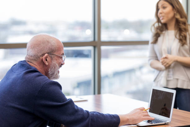 istock Mature adult man enjoys working on computer 1156473606