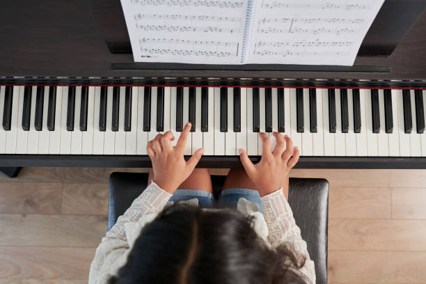 istock Girl playing on musical instrument 1156474308