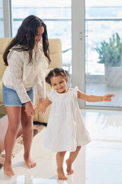istock Girls playing together at home 1156474325