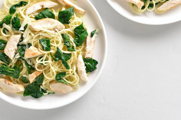 istock Spaghetti with spinach leaves, slices grilled chicken breast and grated cheese 1156475850