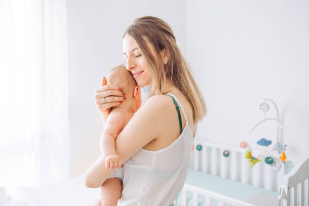 istock Mother carrying baby 1156476456