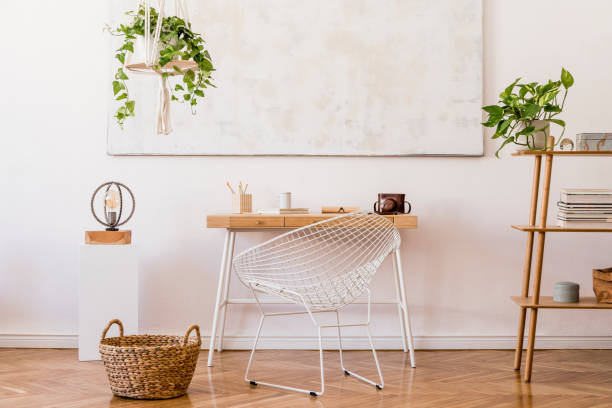 istock Minimalistic boho interior with design and handmade macrame shelf planter hanger for indoor plants, wooden desk, armchair, bamboo shelf and elegant accessories. Stylish home decor. White walls. 1156477841