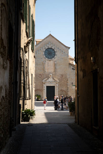 alley that opens on st michael cathedral in albenga. - italy albenga liguria tower imagens e fotografias de stock