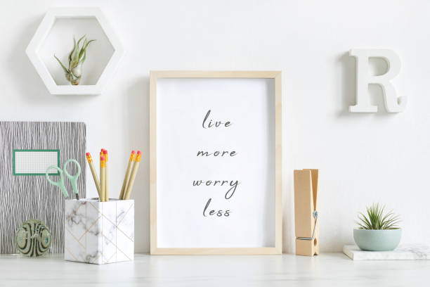 istock Modern and stylish home interior with white mock up poster frame, design office accessories, tapes, supplies, notes, memo sticks, air plants. Scandinavian home decor. Minimalistic concept. Template. 1156479667