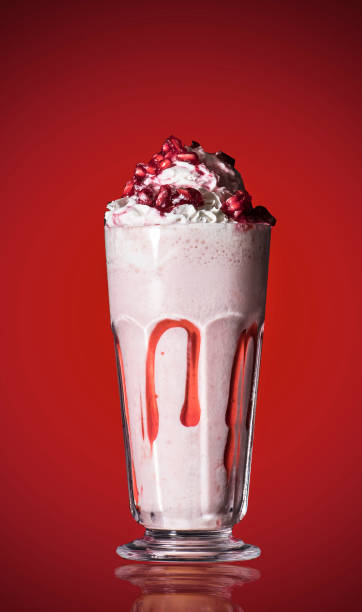 istock Pomegranate smoothie on red isolated background 1156480486