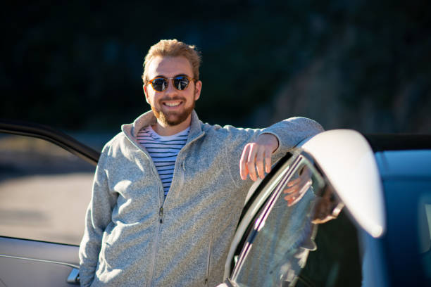 istock Young Man Leaning Against His New Hydrogen Car 1156480559