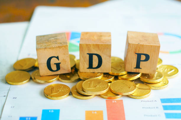 Text "GDP" on wood cube decorate with gold coins on document data, economic data concept. Text "GDP" on wood cube decorate with gold coins on document data, economic data concept. precious metals roth ira stock pictures, royalty-free photos & images