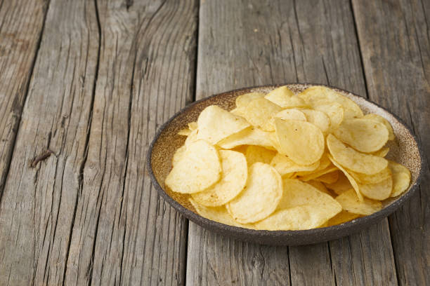 istock crisp in bowl, wooden background, closeup, copy space 1156480642