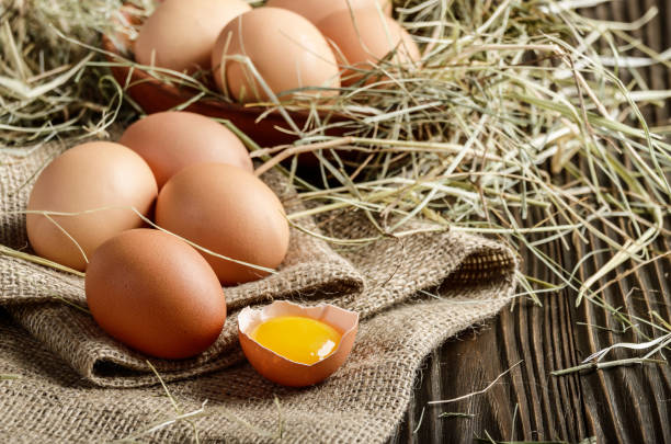 istock Fresh brown organic chicken eggs on wooden table and hemp burlap 1156480699