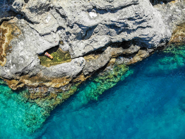 istock Woman floating in desert bay. 1156481496