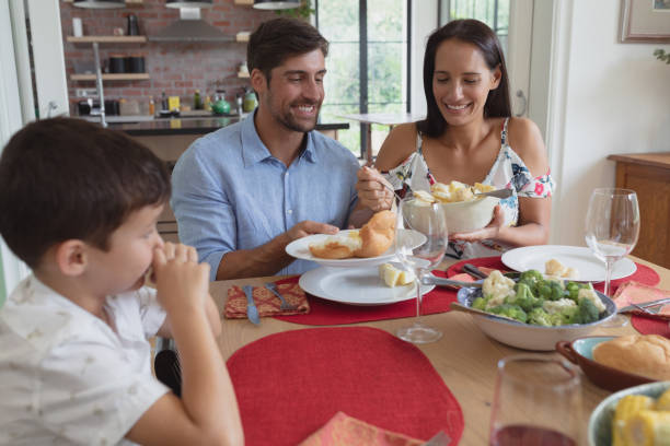 istock Family having food at dinning table in a comfortable home 1156482973