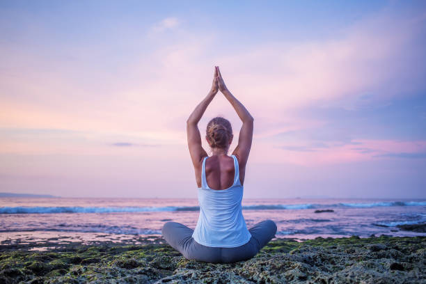 istock Caucasian woman practicing yoga at seashore 1156483178