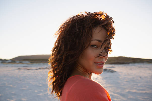 istock Beautiful woman looking at camera on the beach 1156484137
