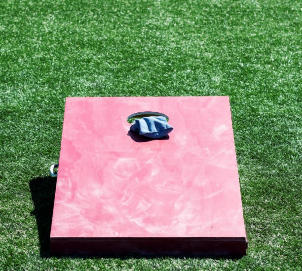 istock Red corn hole game board with bean bag in the whole 1156484236