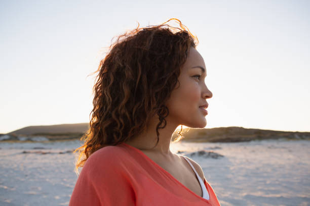 istock Beautiful woman looking away on the beach 1156484329
