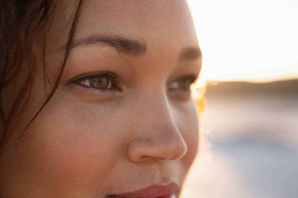 istock Beautiful woman looking away on the beach 1156484380