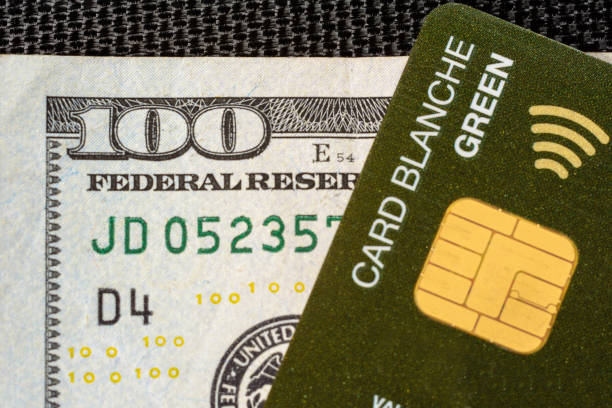 istock Stodolarov's banknote with a credit card where the chip is clearly visible on a black background. 1156484759